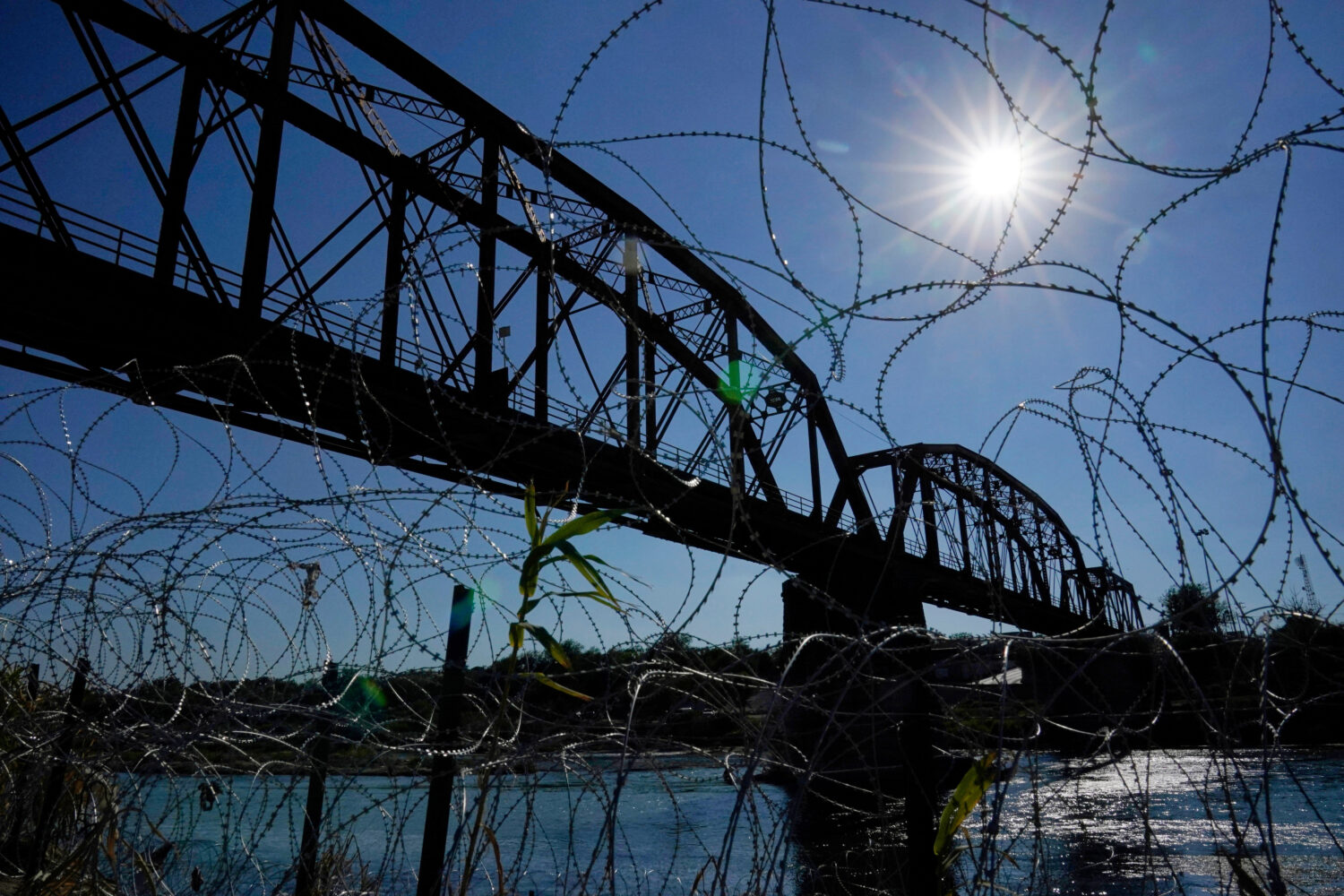 FILE - The Union Pacific International Railroad Bridge is seen behind concertina wire, Sept. 22, 20...