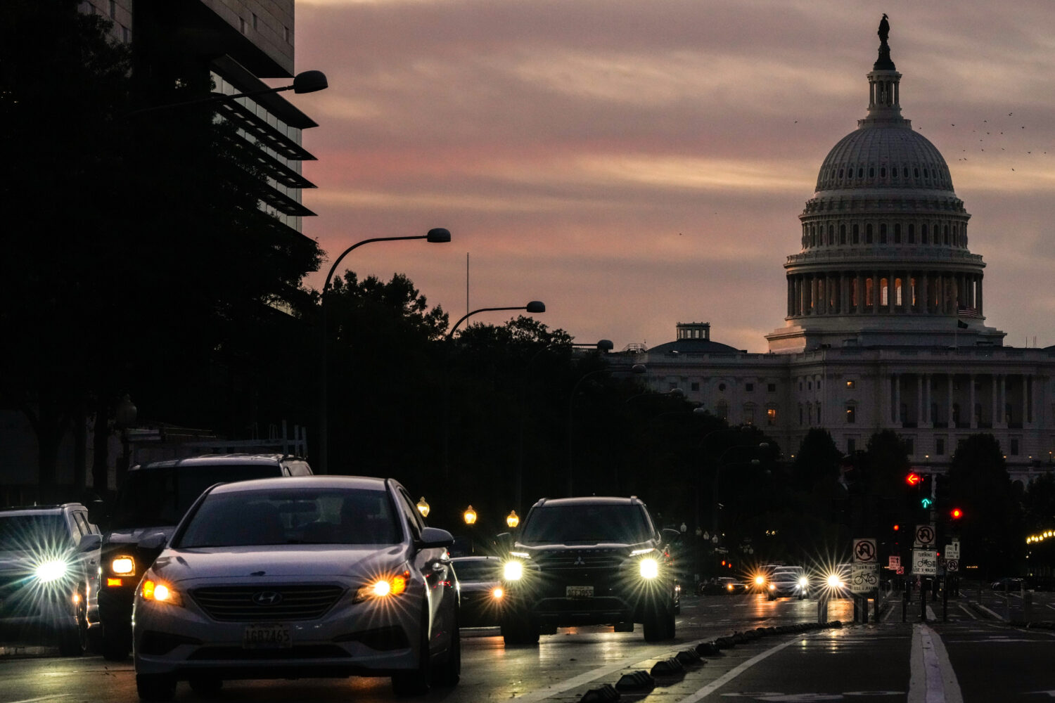 FILE - Vehicles drive along Pennsylvania Ave. during rush hour traffic at sunrise Wednesday, Oct. 1...
