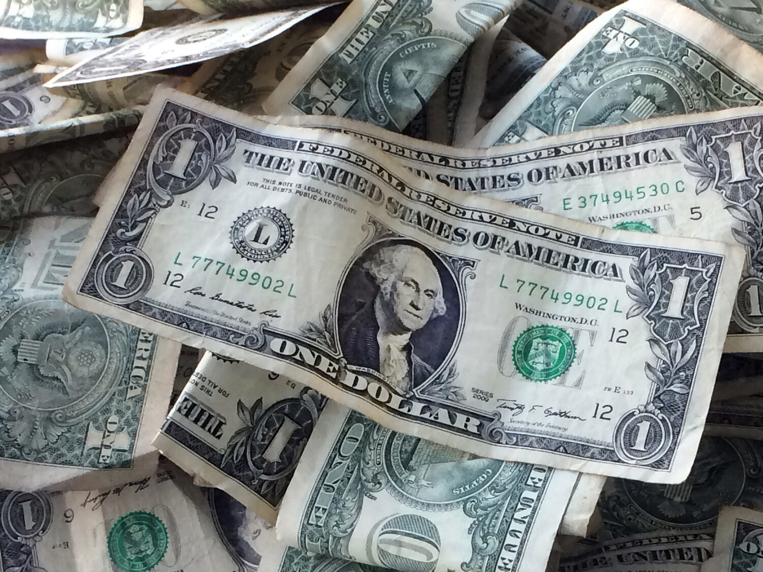 FILE - This Oct. 24, 2016 file photo shows dollar bills in New York. (AP Photo/Mark Lennihan, File)...