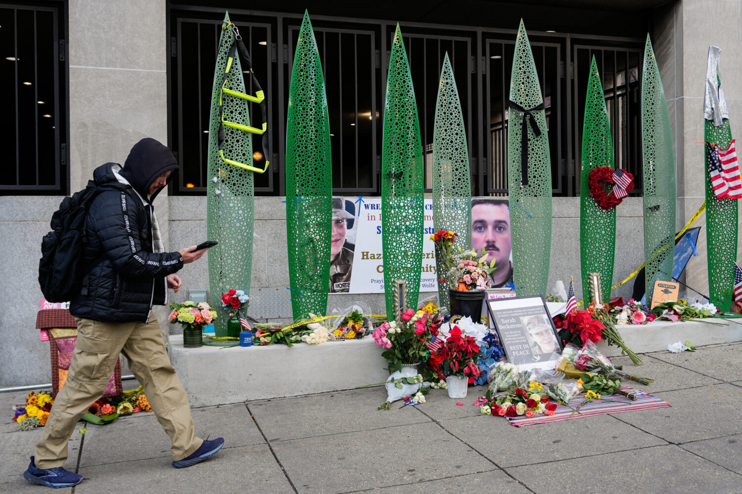 A person walks past a makeshift memorial for U.S. Army Spc. Sarah Beckstrom and U.S. Air Force Staf...