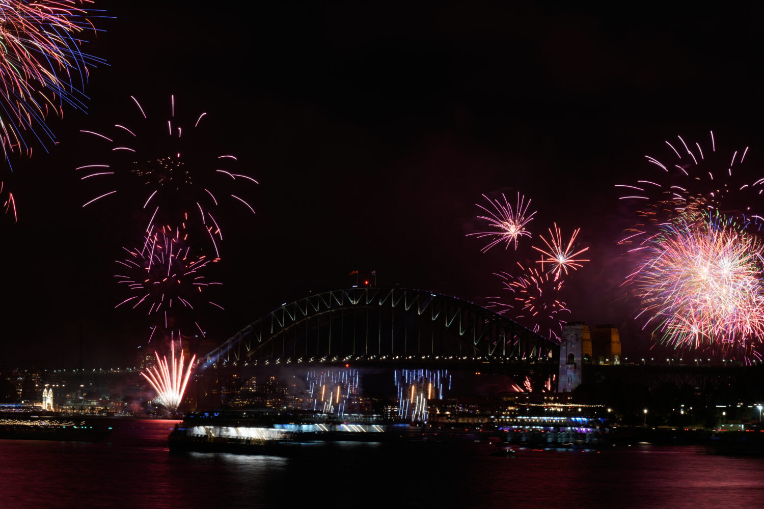 Fireworks burst over the Sydney Harbour Bridge as New Year's celebrations begin in Sydney, Wednesda...