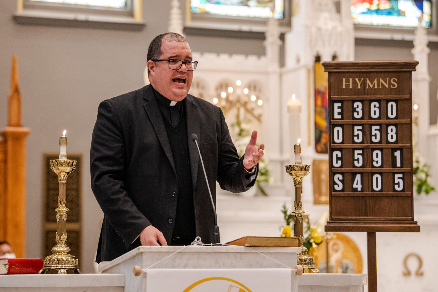 FILE - Rev. Manuel Rodriguez celebrates Mass at Our Lady of Sorrows Catholic Church in the Queens b...