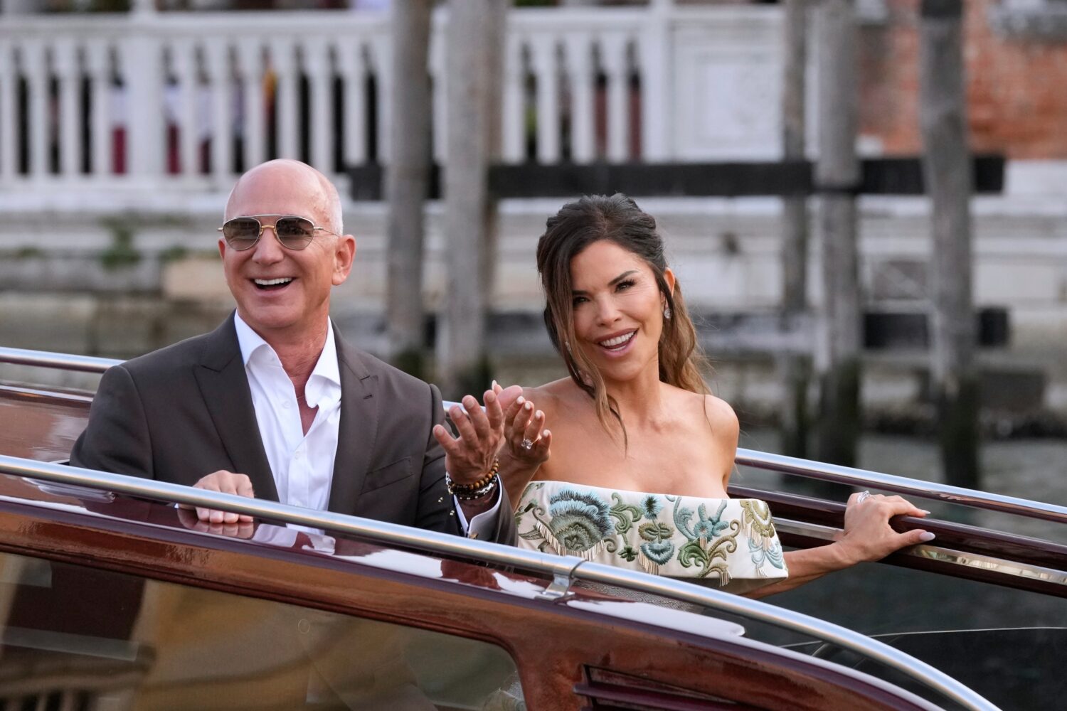 FILE - Jeff Bezos, left, and Lauren Sanchez leave a hotel for their pre wedding reception, in Venic...