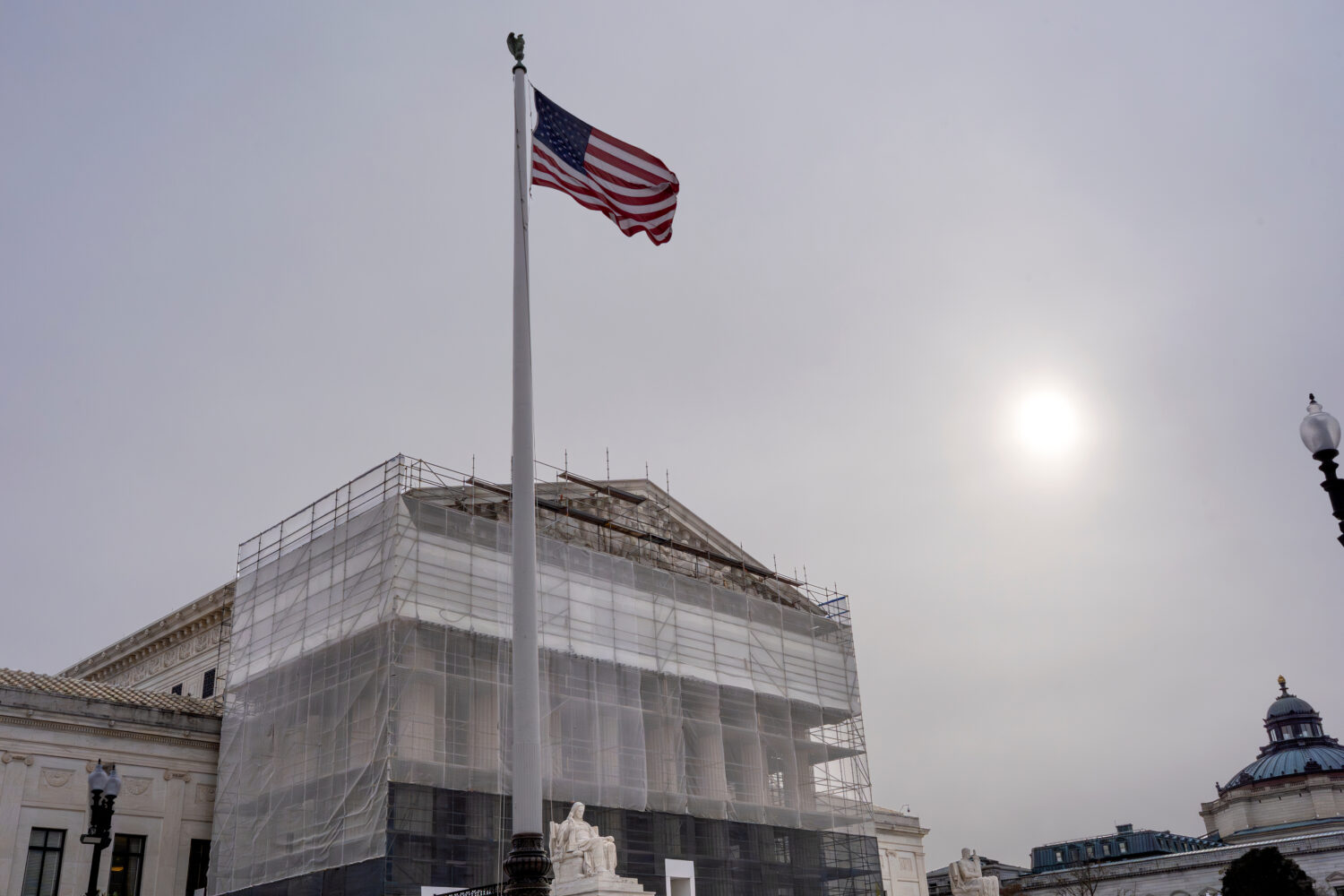 With the Supreme Court Building under renovations, the justices hear oral arguments on President Do...