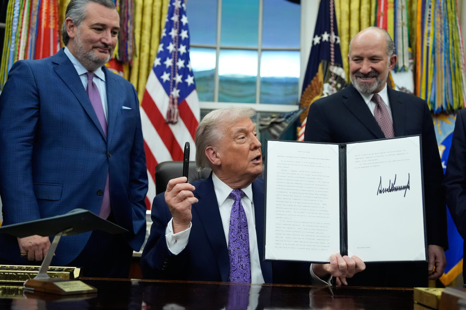 Flanked by Sen. Ted Cruz R-Texas, left, and Secretary of Commerce Howard Lutnick, President Donald ...