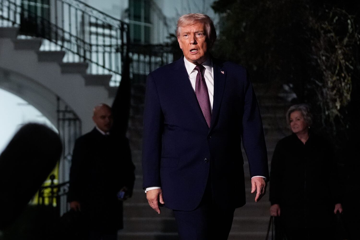 President Donald Trump walks to speak with reporters while departing the White House as chief of st...