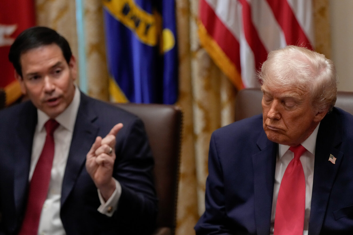 President Donald Trump closes his eyes as Secretary of State Marco Rubio speaks during a Cabinet me...