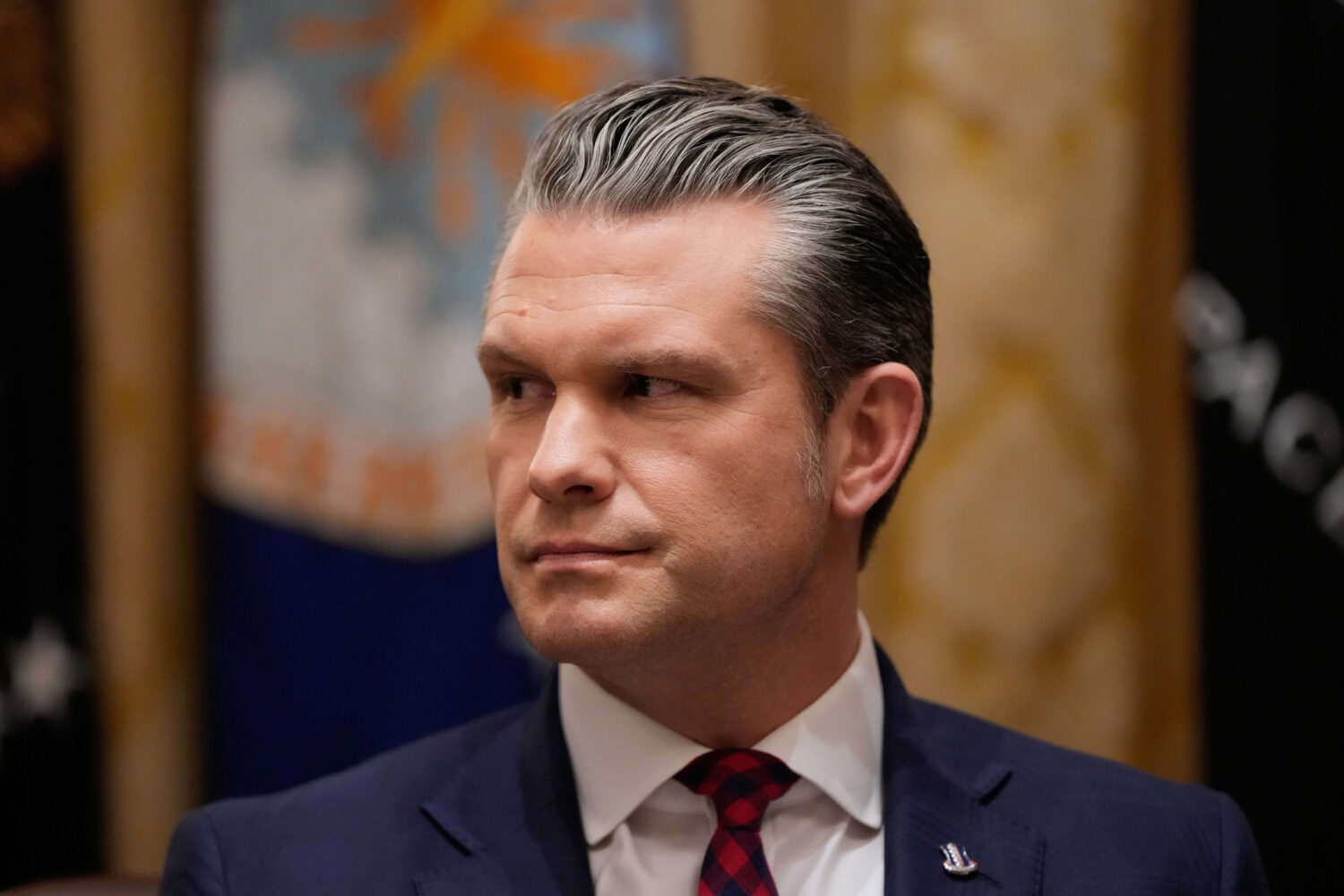 Defense Secretary Pete Hegseth listens as President Donald Trump speaks during a Cabinet meeting at...