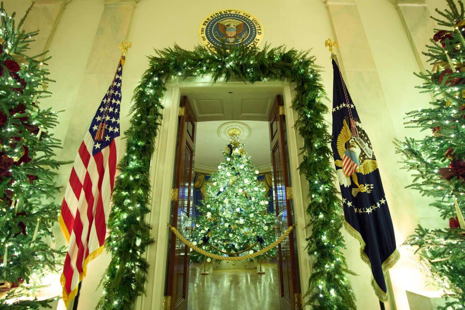 Christmas trees decorate the Cross Hall of the White House during a press preview of the Christmas ...