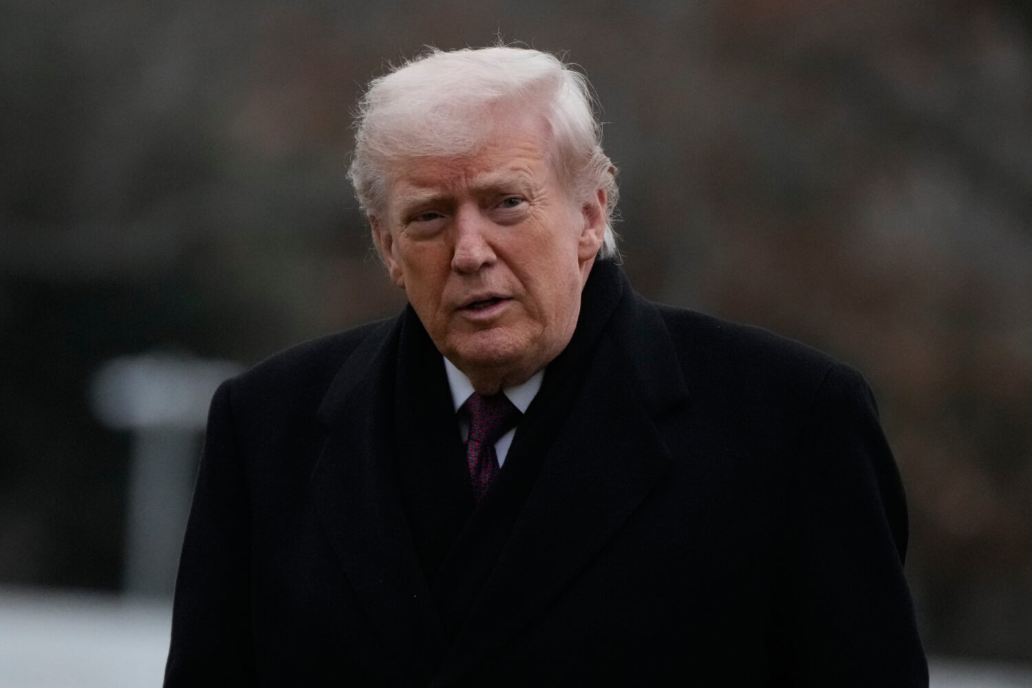 President Donald Trump looks over after stepping off Marine One on the South Lawn of the White Hous...