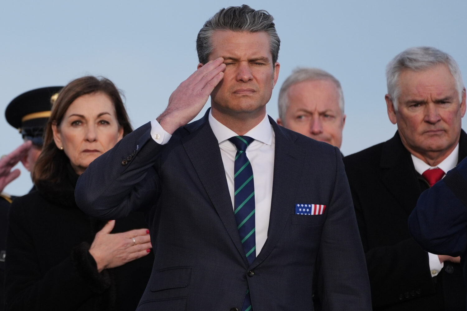Defense Secretary Pete Hegseth salutes during a casualty return for Iowa National Guard soldiers Sg...