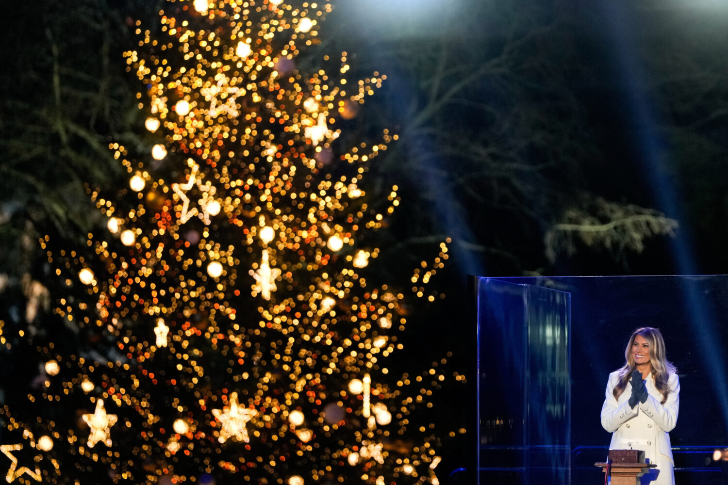 First lady Melania Trump claps after lighting the National Christmas Tree on the Ellipse, Thursday,...