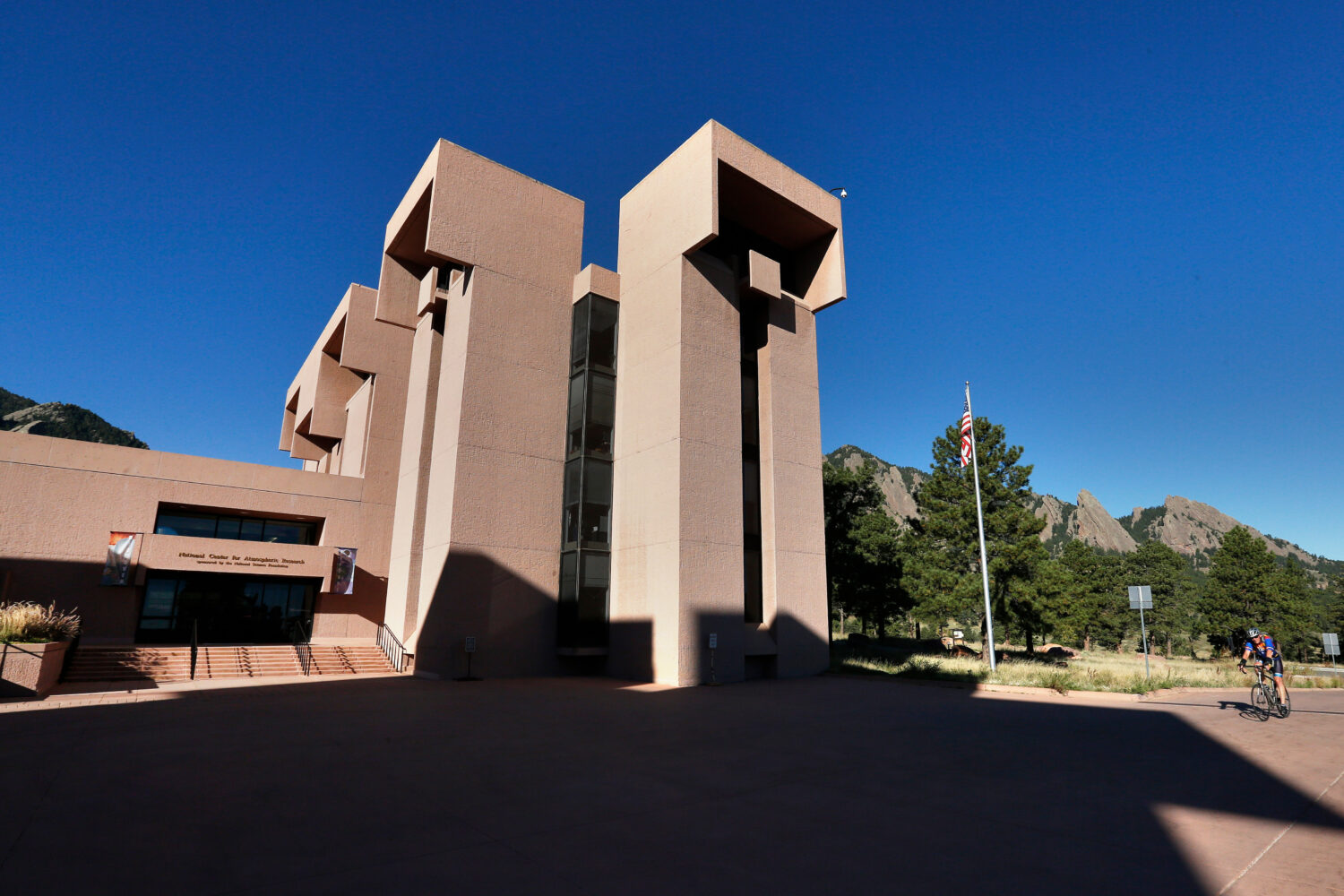 FILE - A man rides a bike to work at a U.S. National Center for Atmospheric Research facility in Bo...