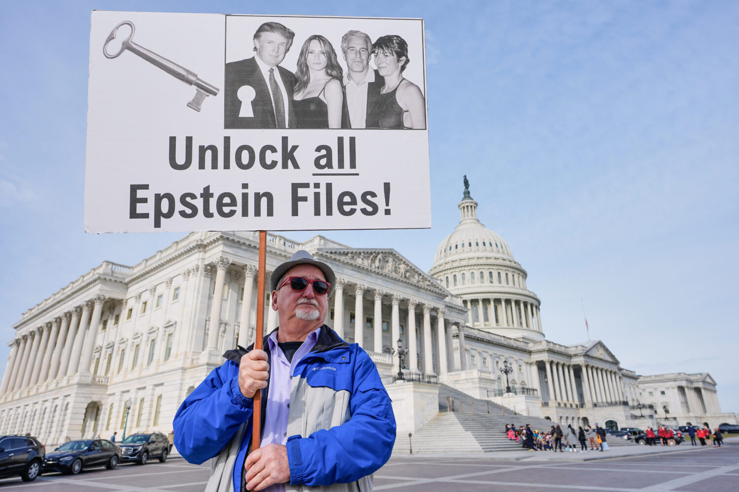 FILE - Gary Rush, College Park, MD, holds a sign before a news conference on the Epstein files in f...