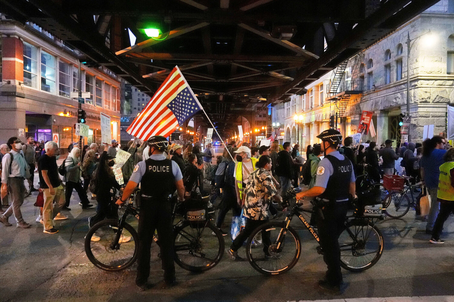 FILE - Police officers block a street as demonstrators march at a protest opposing "Operation Midwa...