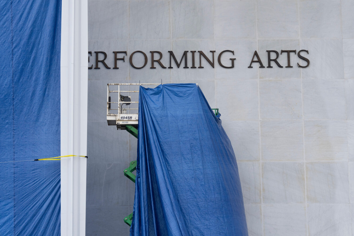 Tarps are installed in front of the sign on the Kennedy Center on Friday, Dec. 19, 2025, in Washing...
