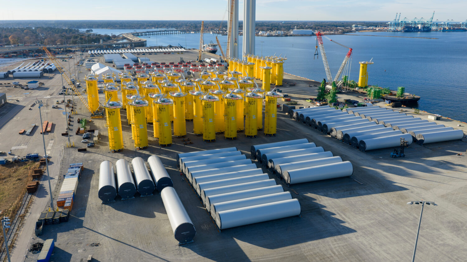 Wind turbine bases, generators and blades are positioned along with support ships at The Portsmouth...