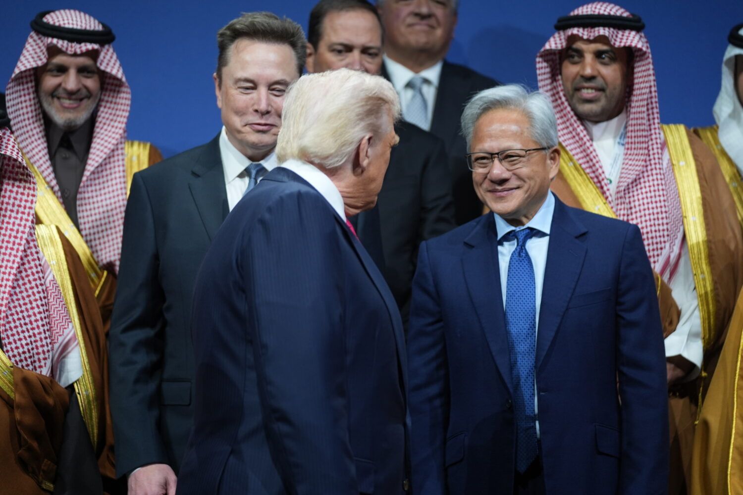 President Donald Trump speaks with Elon Musk and Nvidia CEO Jensen Huang, during the Saudi Investme...