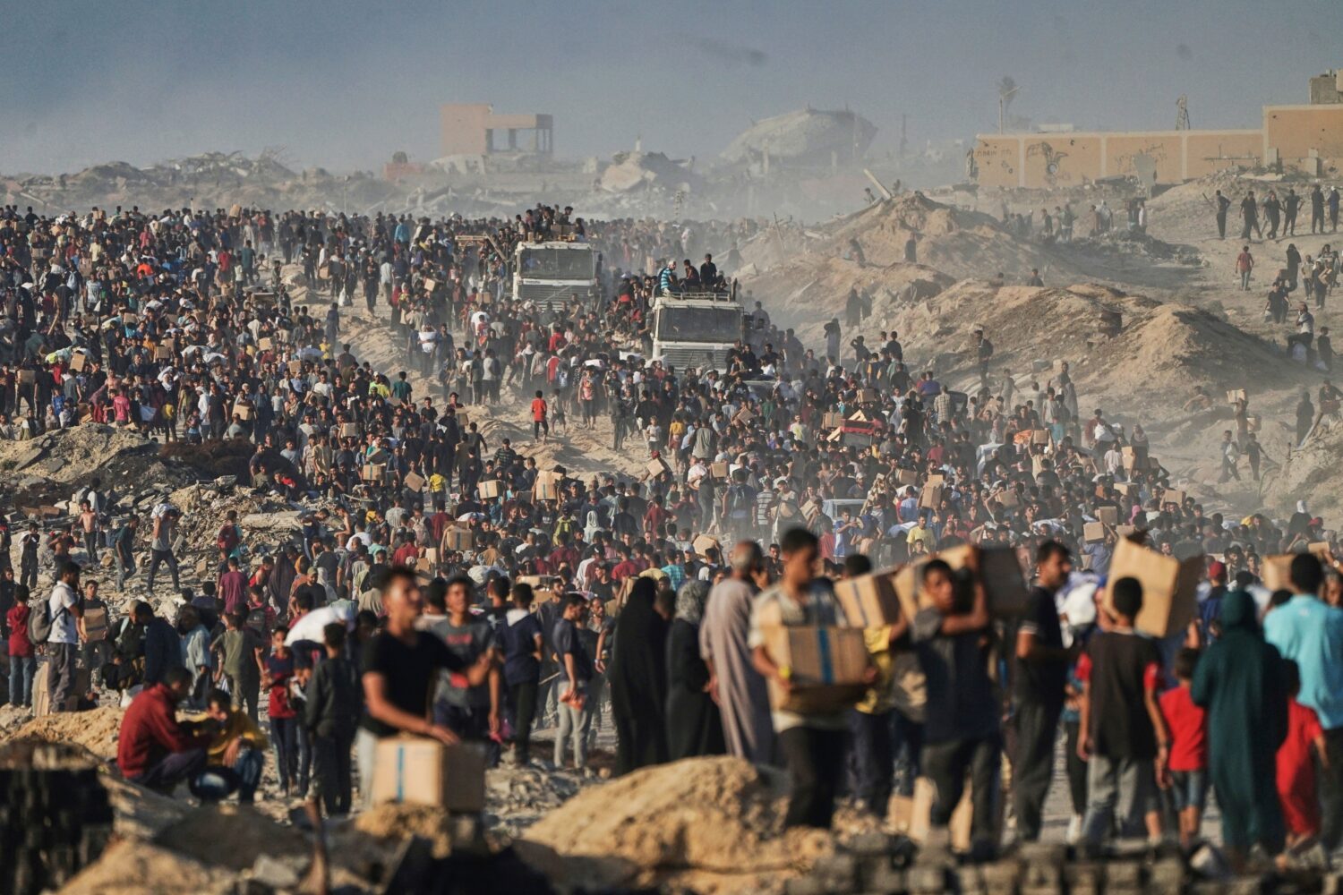 FILE - People carry sacks and boxes of food and humanitarian aid that was unloaded from a World Foo...
