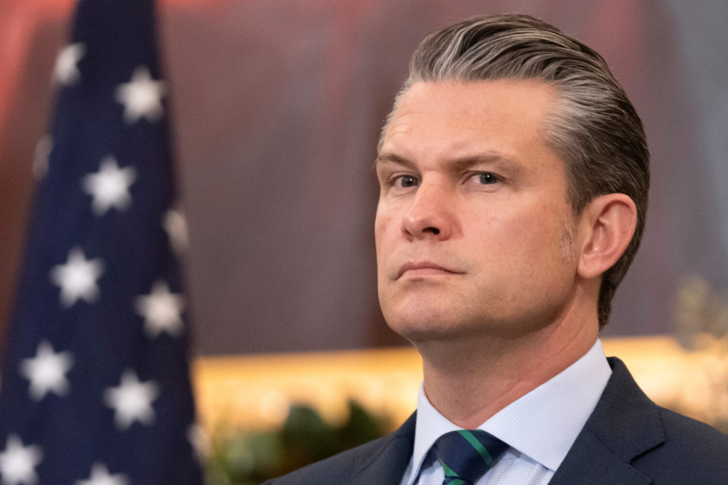 Defense Secretary Pete Hegseth listens during an event at the State Department, Monday, Dec. 8, 202...