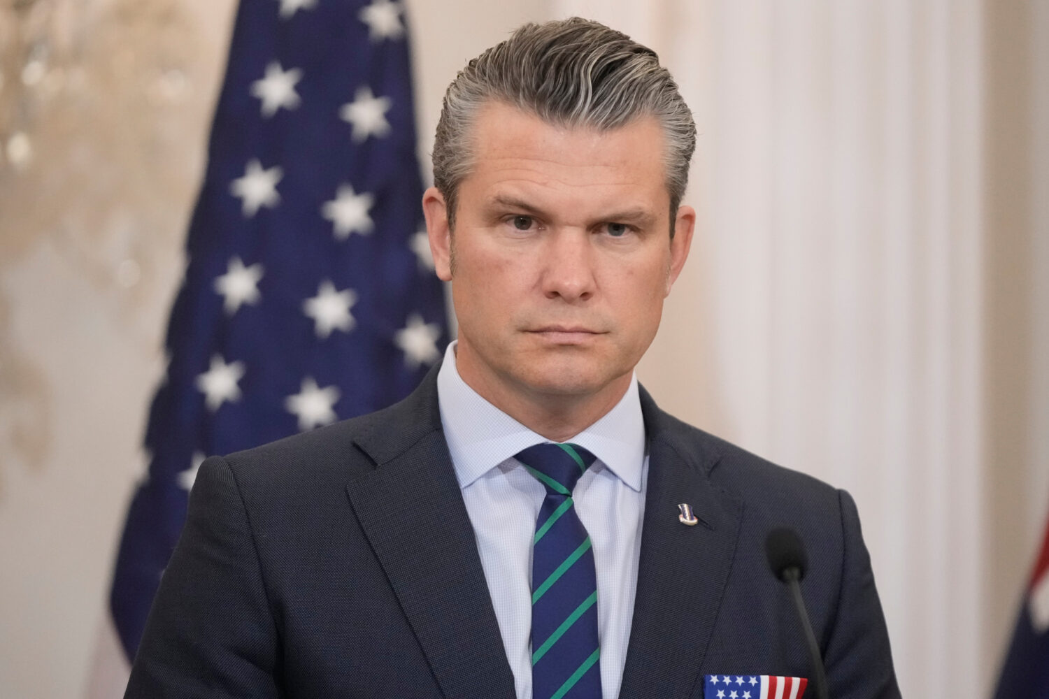 Defense Secretary Pete Hegseth listens during news conference with Australia's Deputy Prime Ministe...