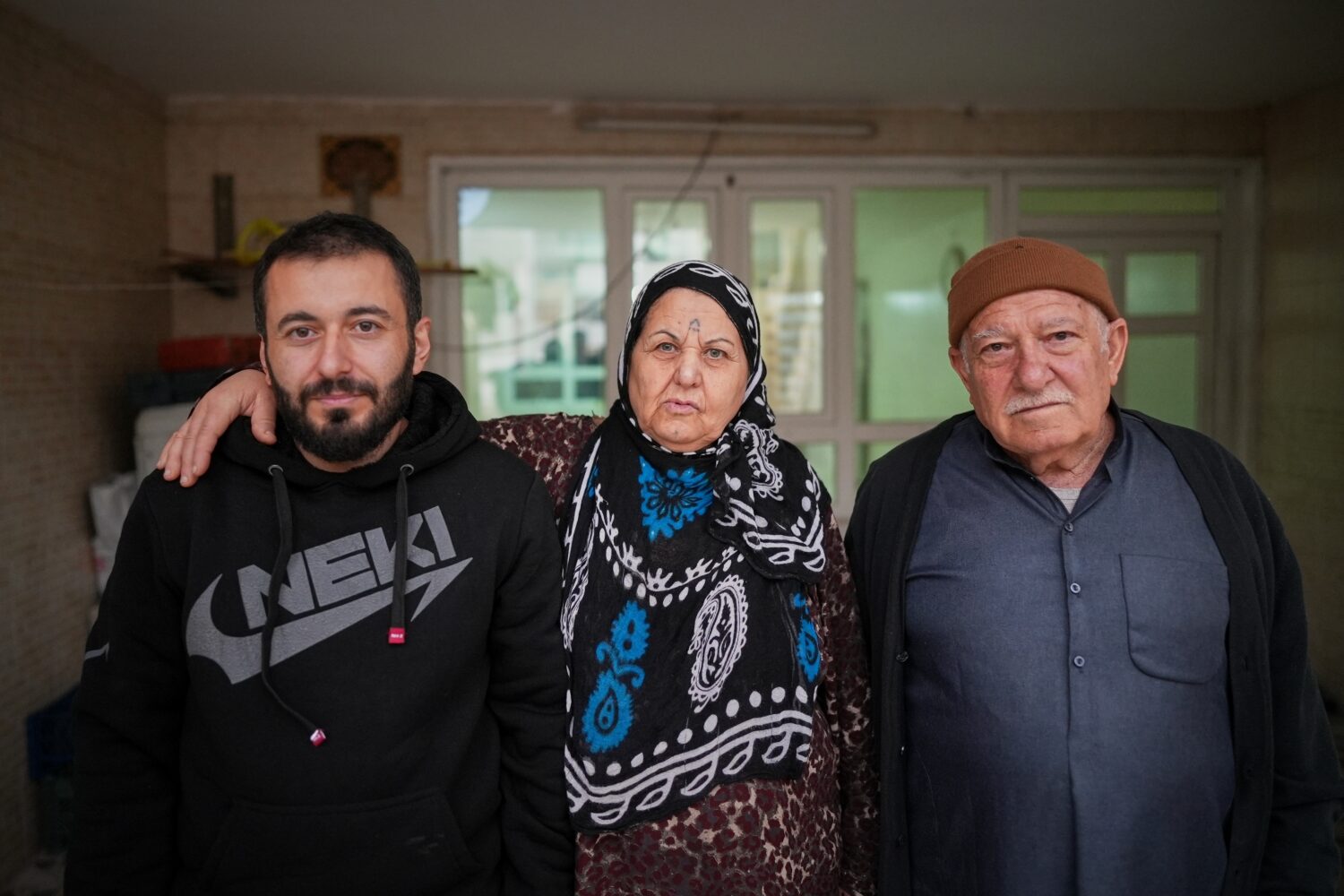 Syrian refugee Mohammed Dawood, 30, left, poses for a photo with his parents, Hayat Fatah, 65, cent...