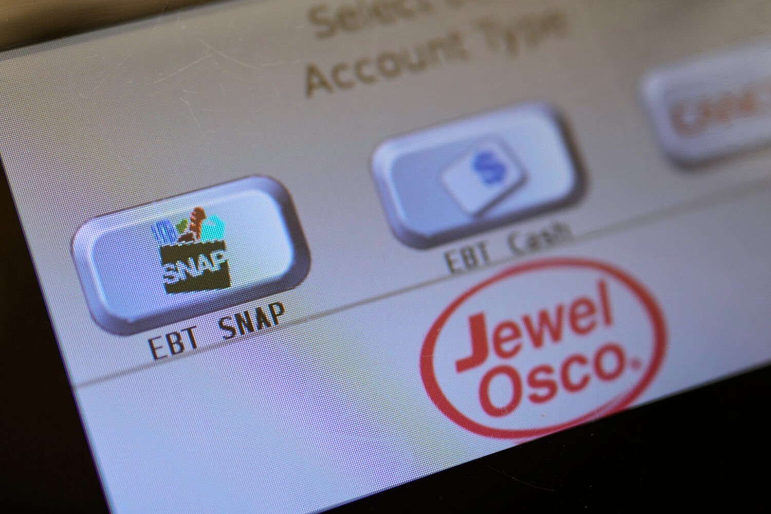 FILE - An EBT SNAP sign is shown on a self check out screen at a grocery store in Mount Prospect, I...