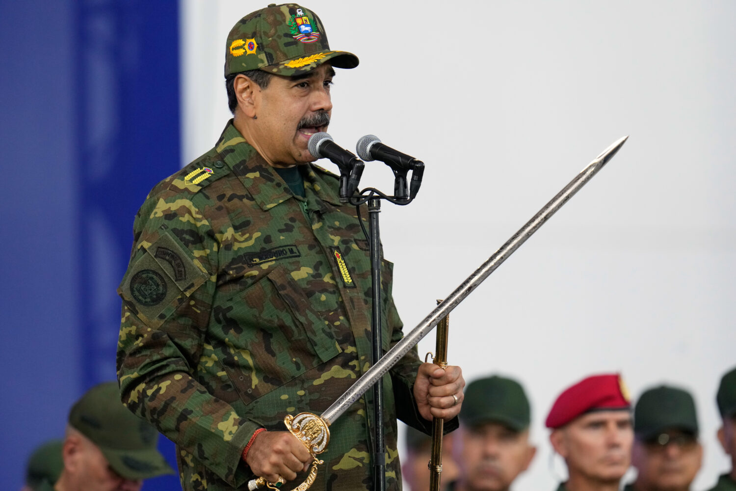 Venezuelan President Nicolas Maduro holds a ceremonial sword said to have belonged to independence ...