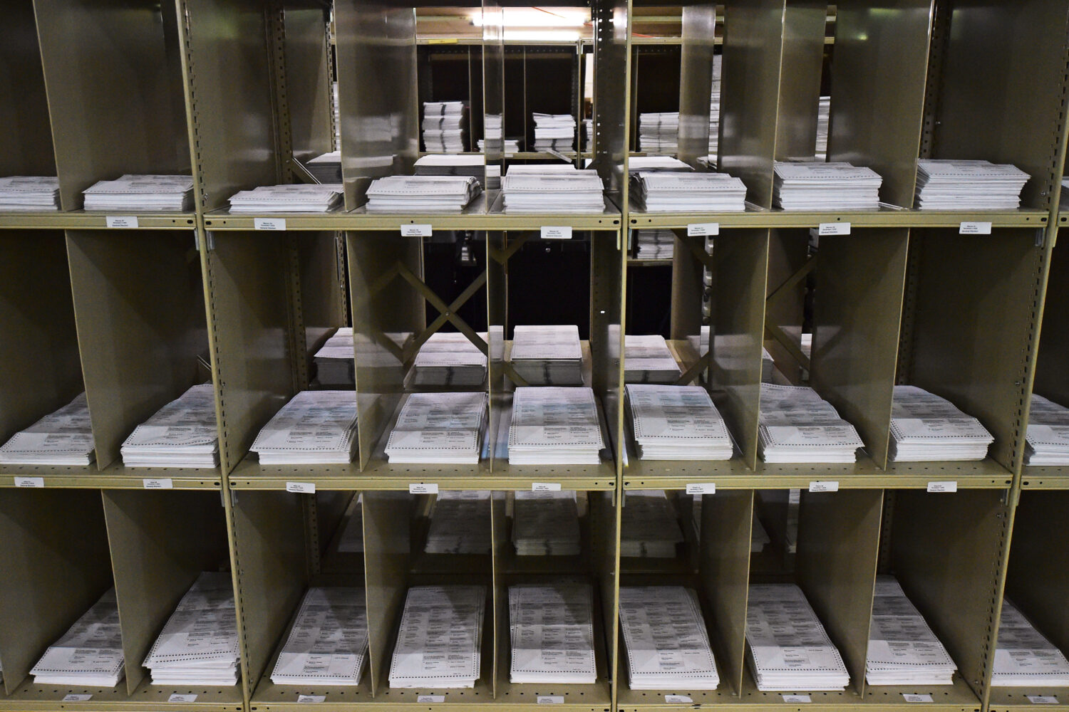 FILE - Mail-in ballots sit on shelves inside the Trumbull County Board of Elections, Nov. 3, 2020, ...