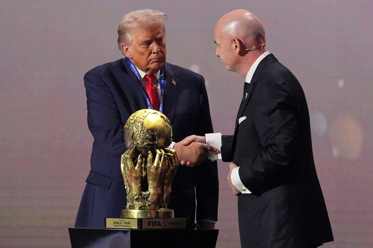 President Donald Trump receives the FIFA Peace Prize from FIFA President Gianni Infantino during th...