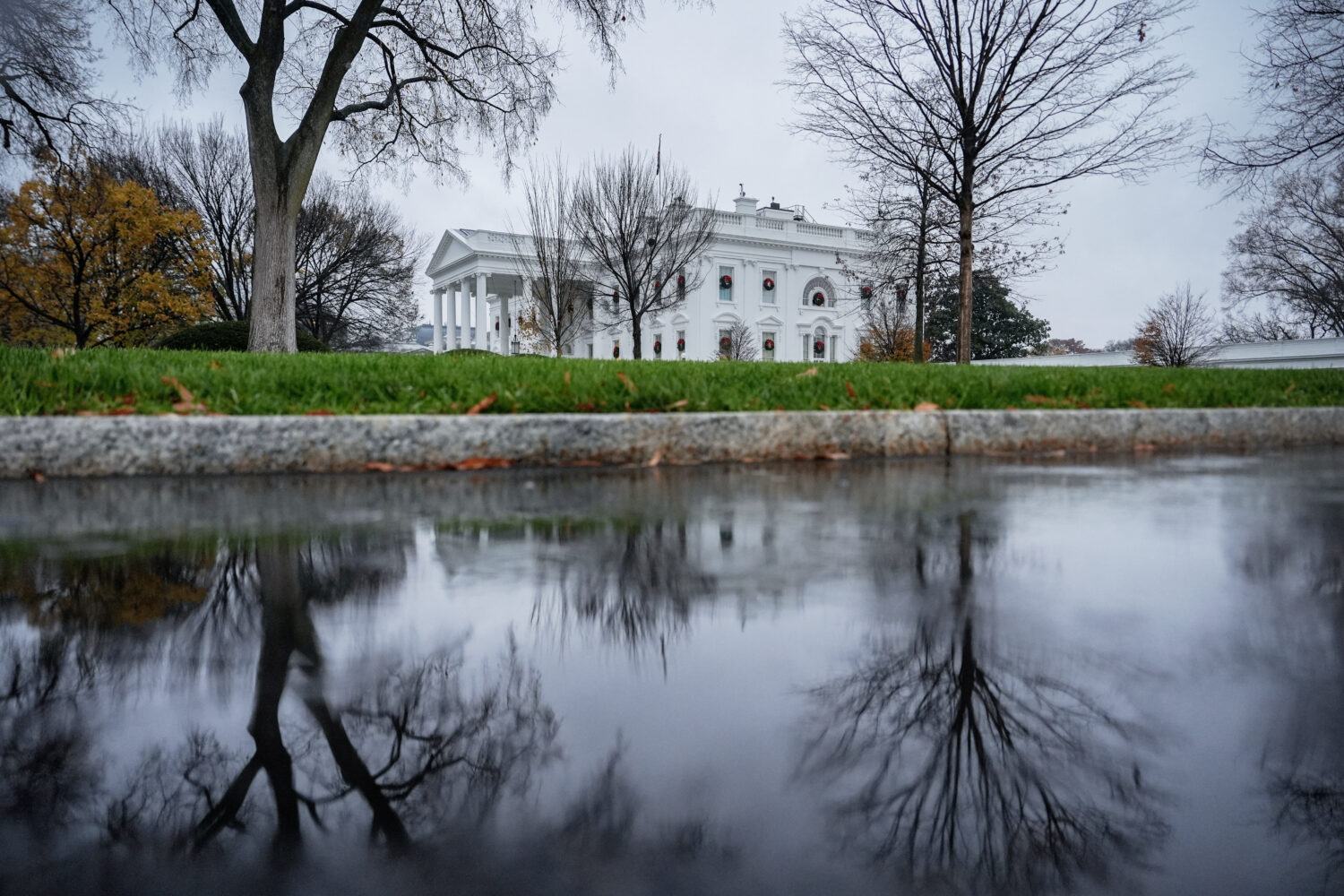 FILE - The White House is reflected in a puddle, Dec. 2, 2025, in Washington. (AP Photo/Julia Demar...
