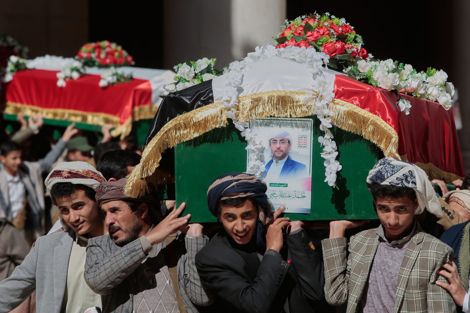 Houthi supporters carry the coffins of 5 leaders, who they said were killed during previous Israeli...