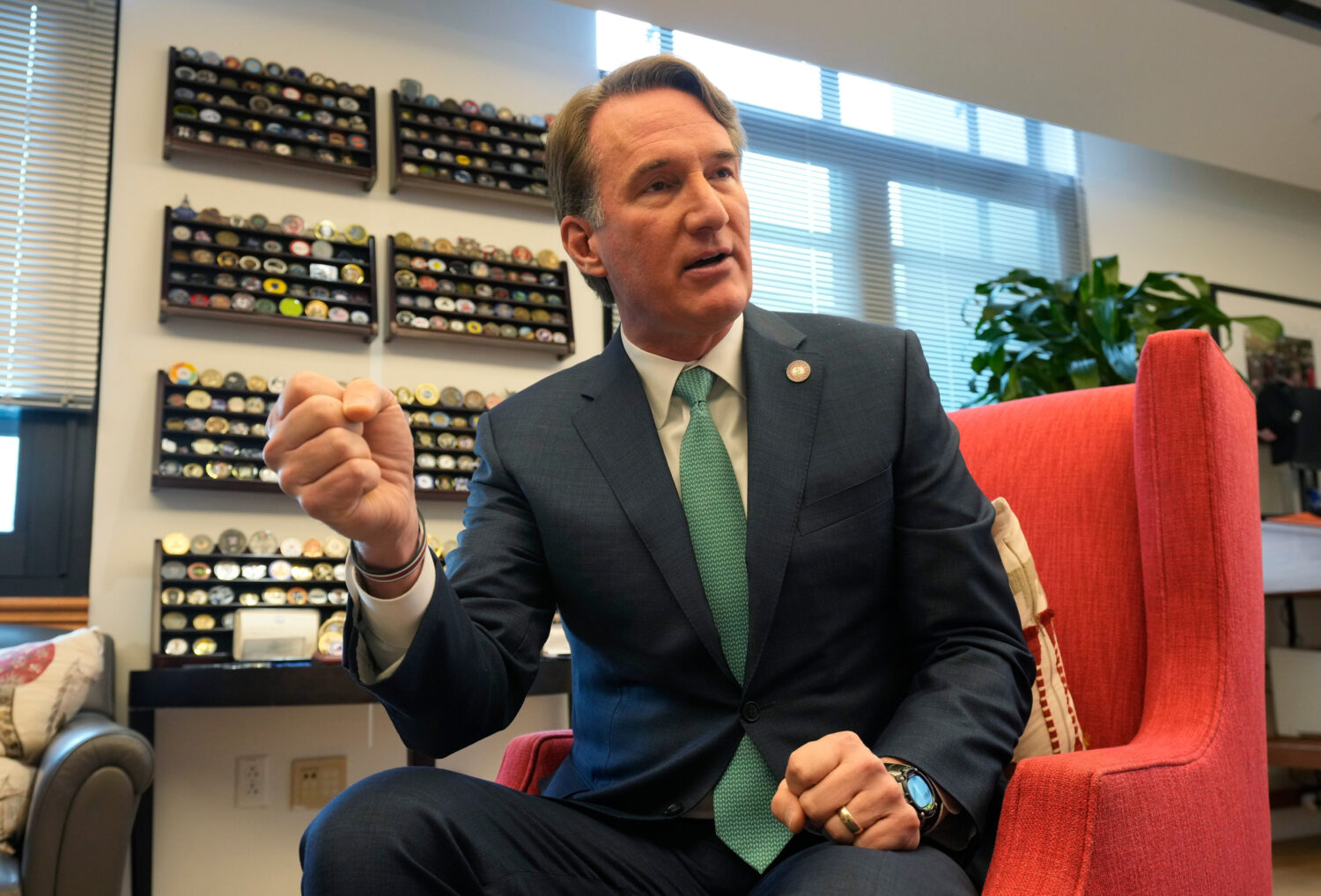 Virginia Gov. Glenn Youngkin gestures during an interview in his office at the Capitol Wednesday De...
