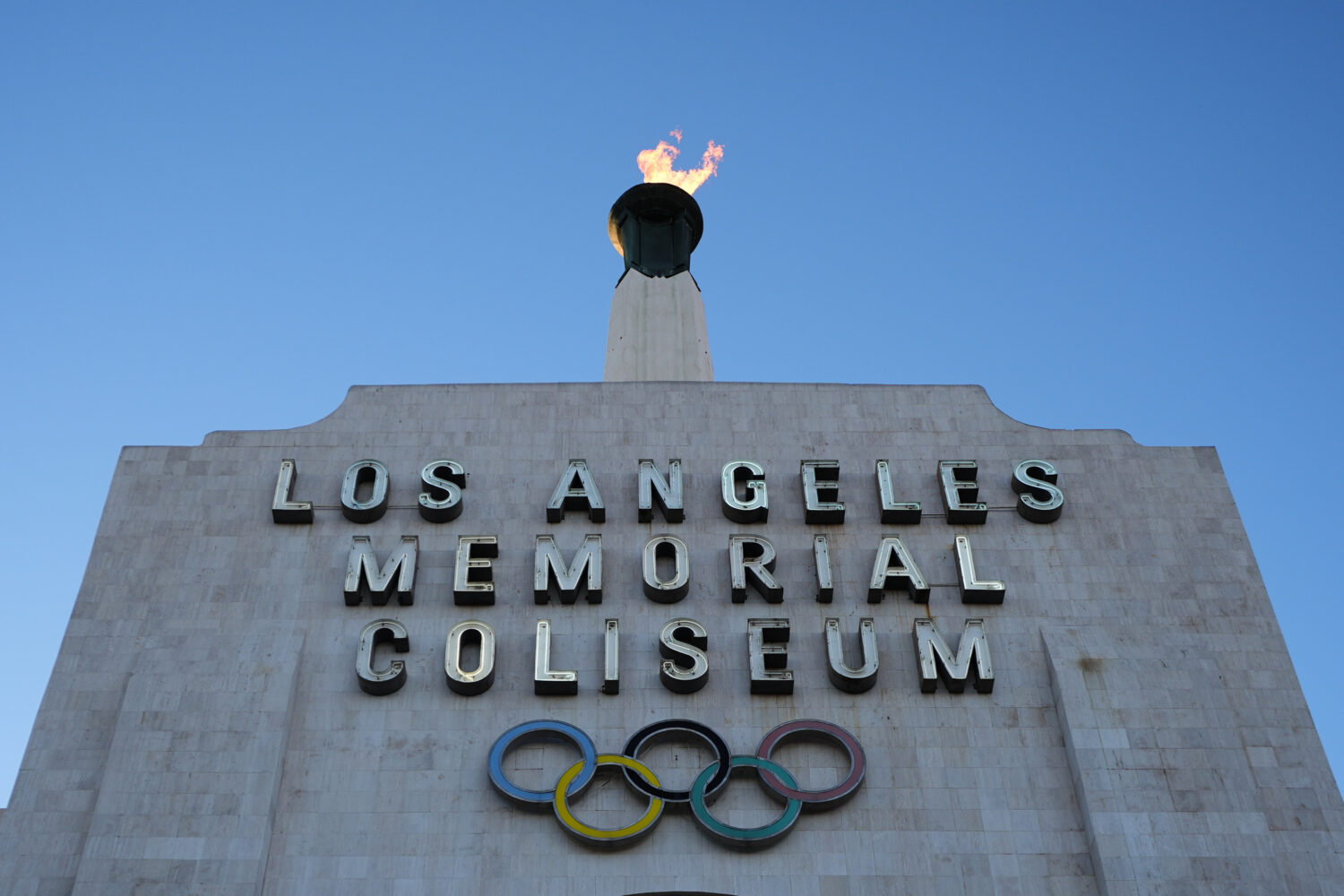The Olympic cauldron is lit at the Los Angeles Memorial Coliseum ahead of the launch for ticket reg...