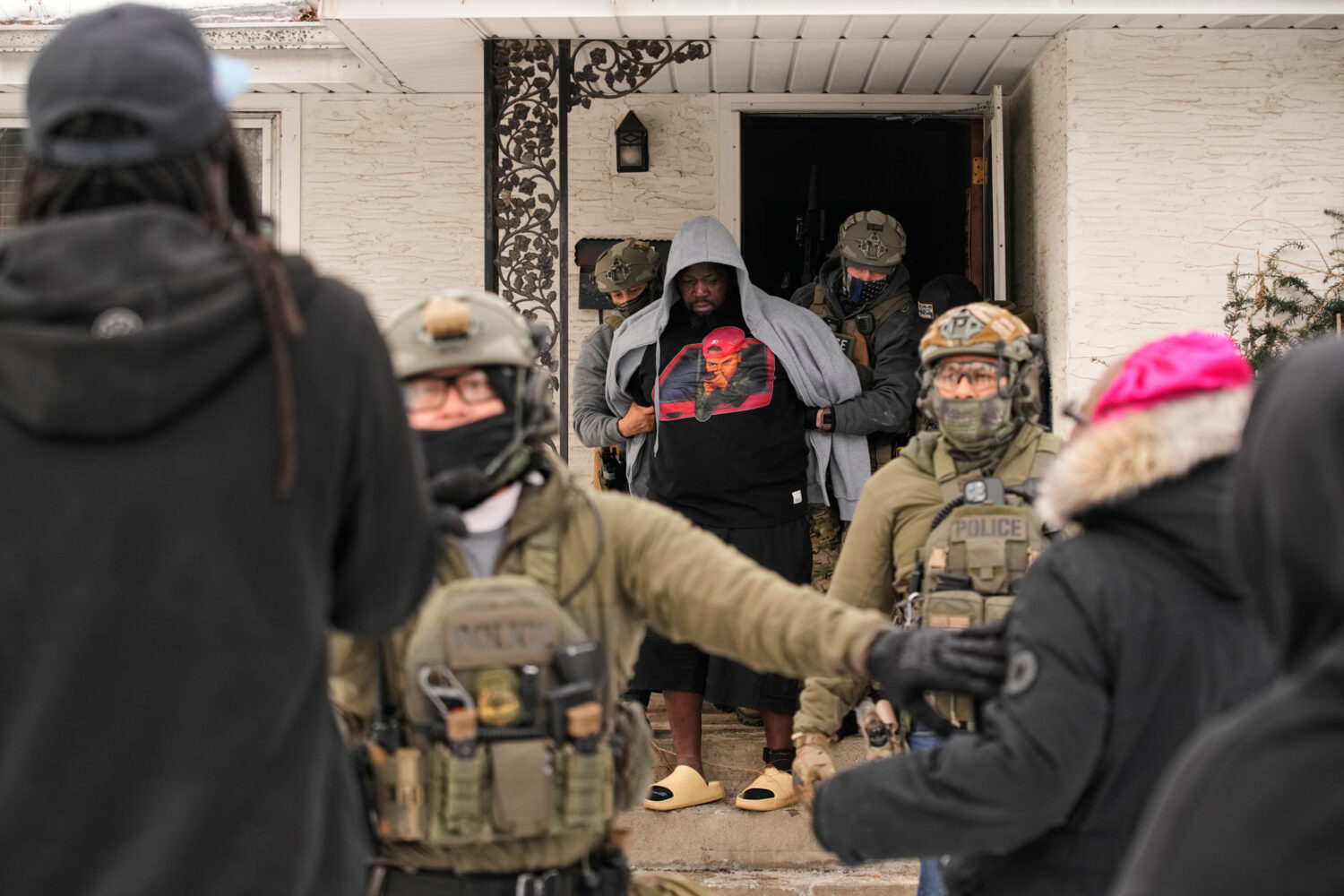 ADDS IDENTIFICATION: Garrison Gibson is arrested by federal immigration officers Sunday, Jan. 11, 2...