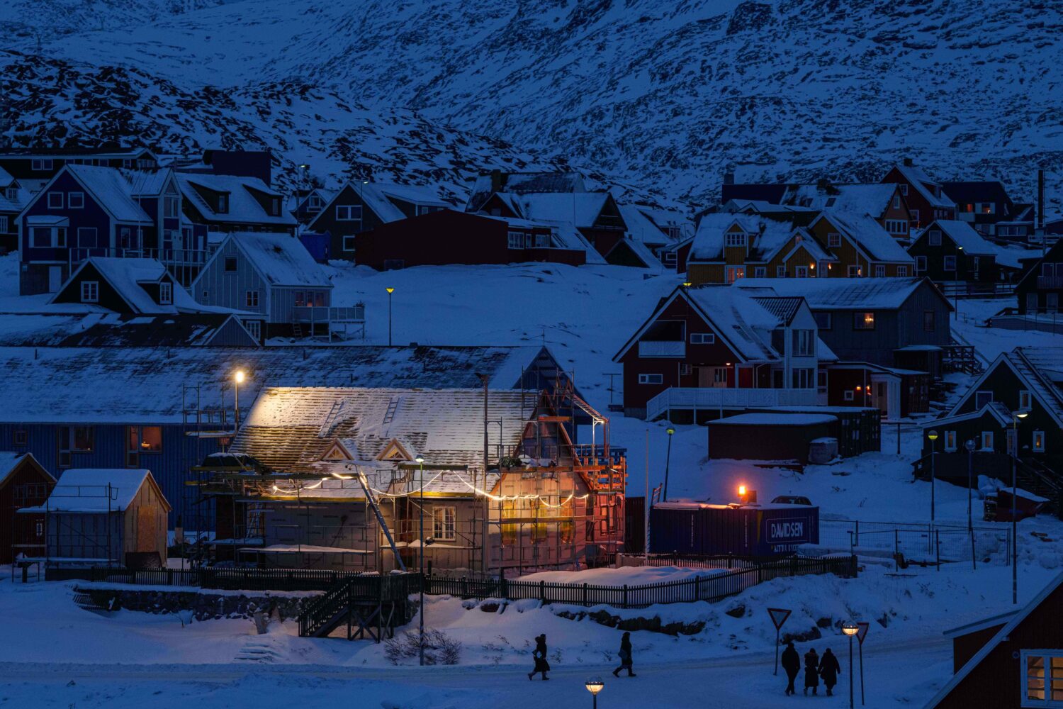 People walk along a street in downtown of Nuuk, Greenland, on Tuesday, Jan. 13, 2026. (AP Photo/Evg...