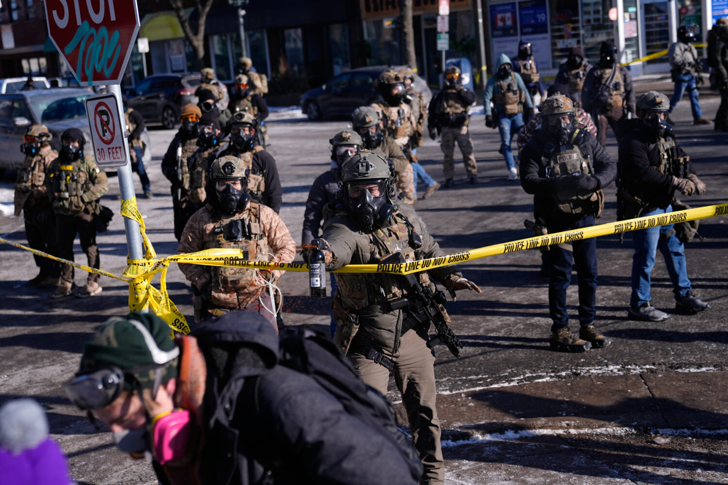 Federal immigration officers deploy pepper spray at observers after a shooting Saturday, Jan. 24, 2...