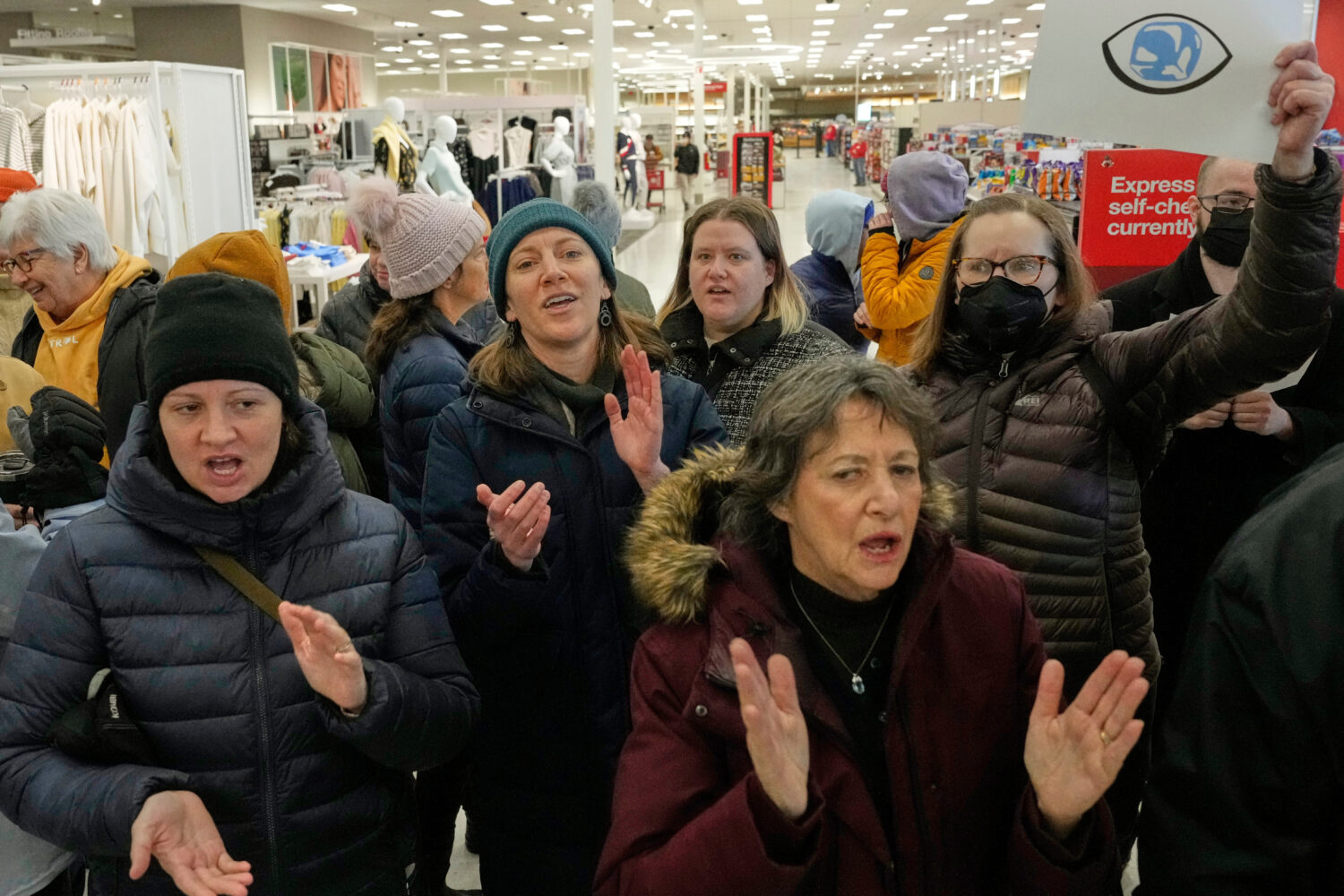 Community members and neighbors of people detained by ICE protest at a Target store, Monday, Jan. 1...