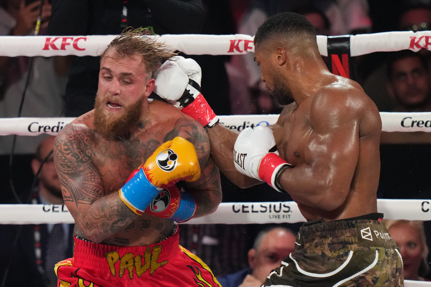 Anthony Joshua, right, punches Jake Paul during their heavyweight boxing match, Friday, Dec. 19, 20...