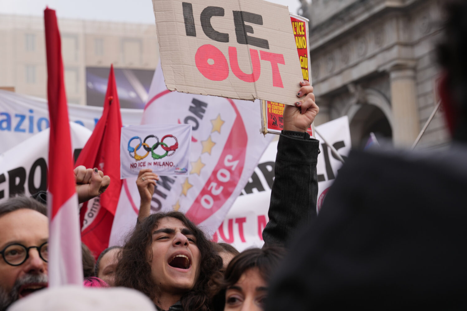 A person holds a sign, during an Anti-ICE demonstration, ahead of the 2026 Winter Olympics, in Mila...
