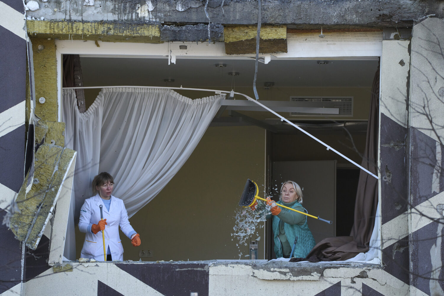 Medical workers remove the debris in a damaged private clinic after, according to Ukrainian officia...