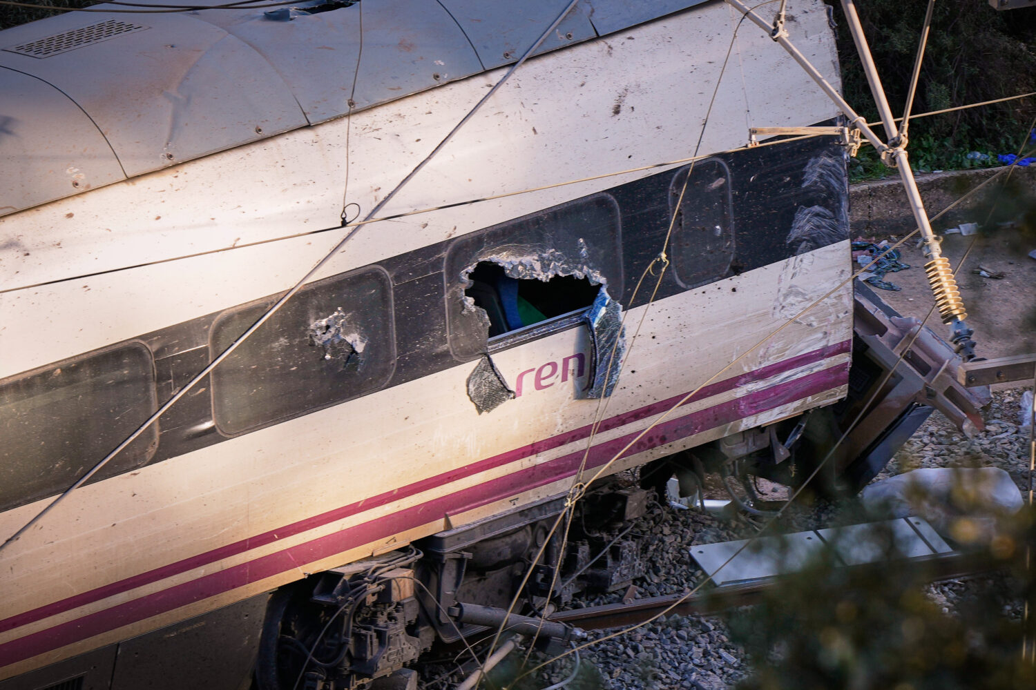 Part of a wrecked train is photographed at the site of a train collision in Adamuz, southern Spain,...