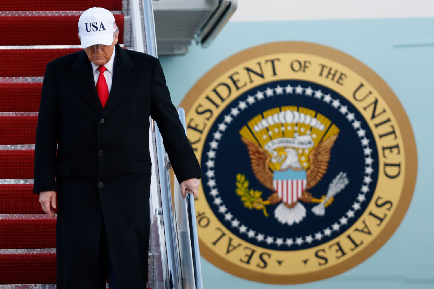 President Donald Trump walks down the stairs of Air Force One upon his arrival at Joint Base Andrew...
