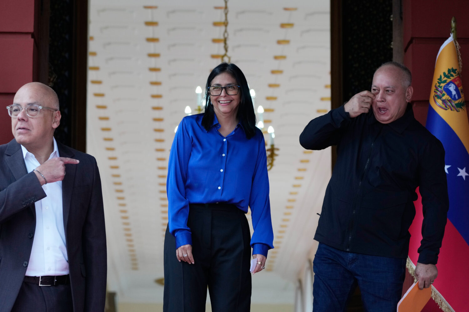 Venezuela's acting President Delcy Rodriguez, center, smiles flanked by Interior Minister Diosdado ...