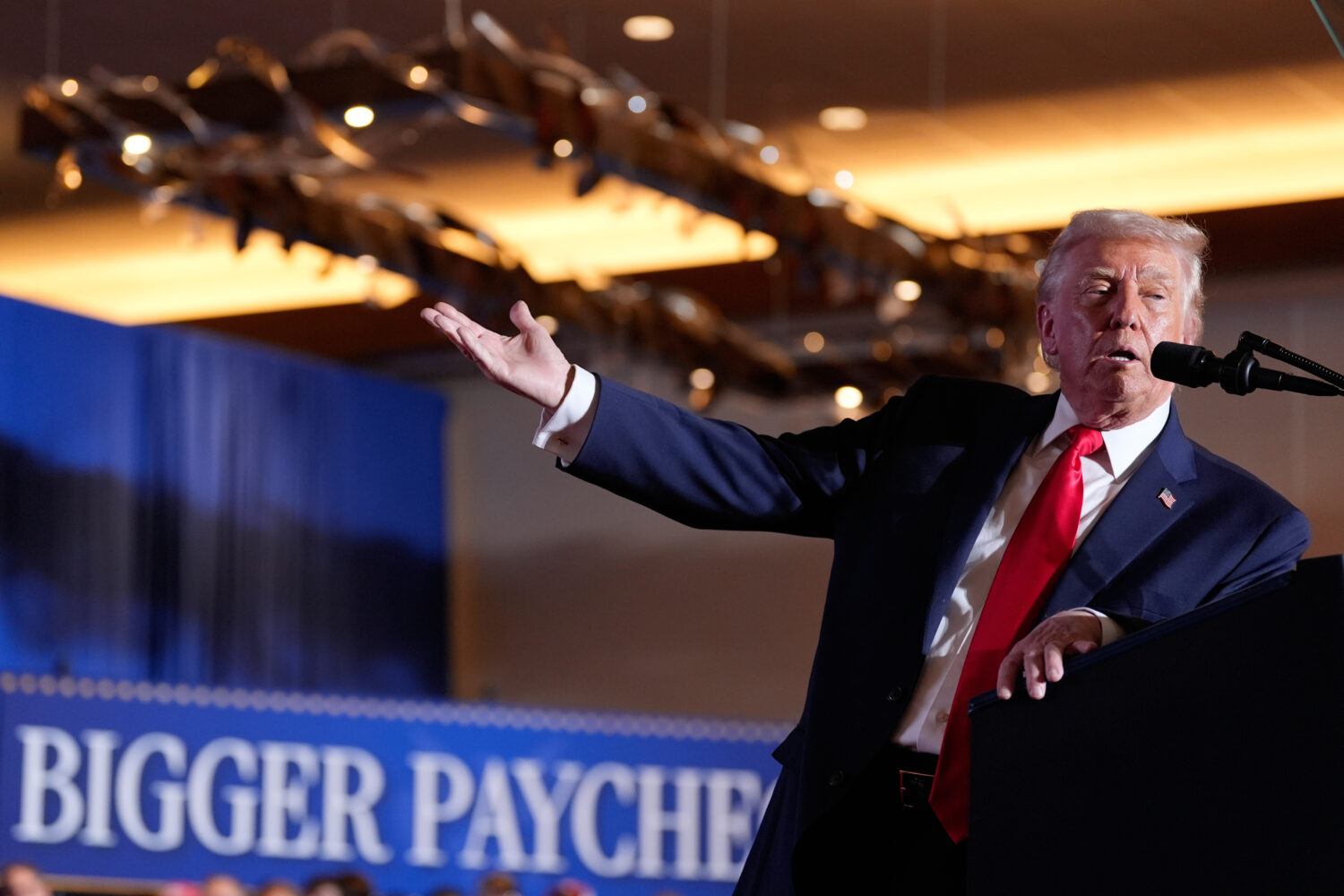 FILE - President Donald Trump gestures to a chart as he speaks at Mount Airy Casino Resort, Dec. 9,...