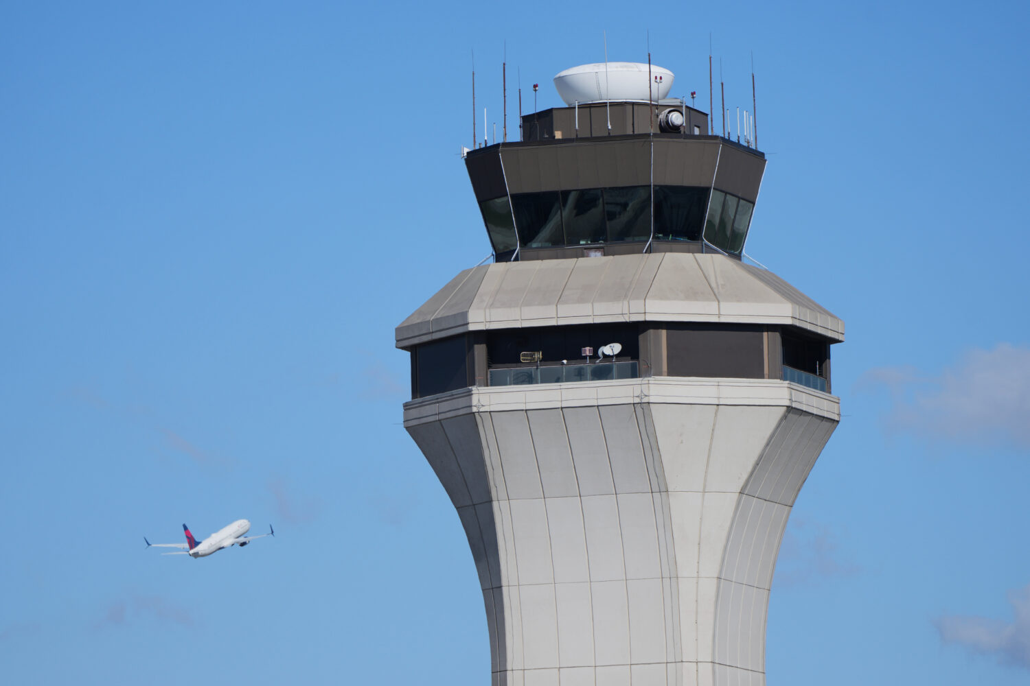 FILE - A flight departs past the control tower at Detroit Metropolitan Wayne County Airport, Oct. 2...