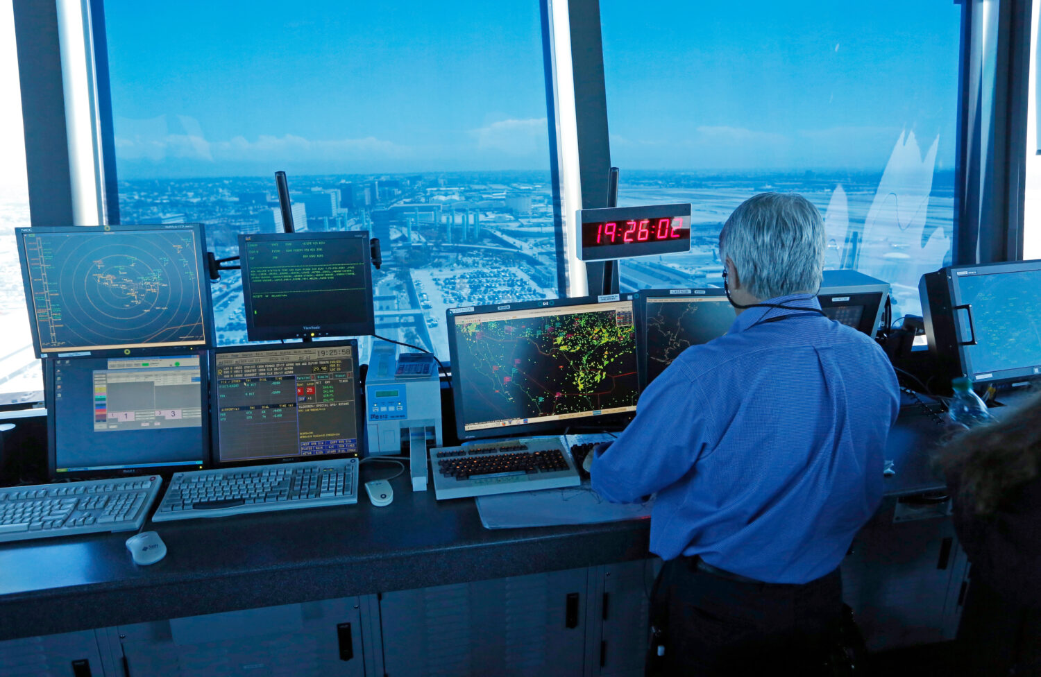 FILE - In this Sept. 4, 2013 photo, an air traffic controller works at computer screens and a digit...