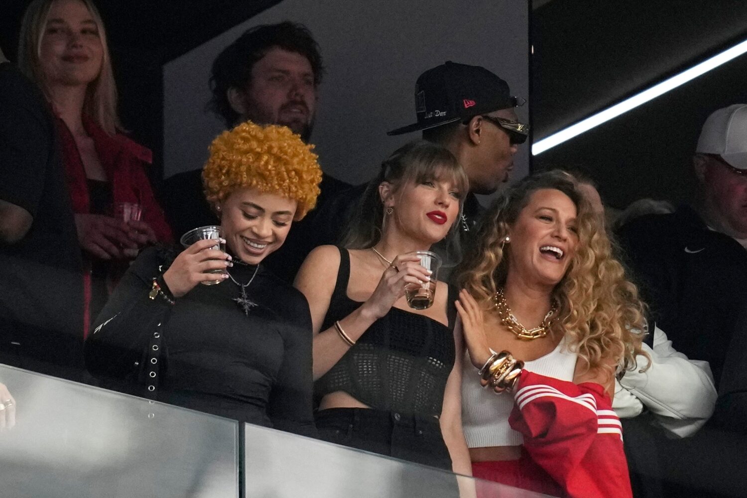 FILE - Taylor Swift, center, watches the teams before the NFL Super Bowl 58 football game between t...