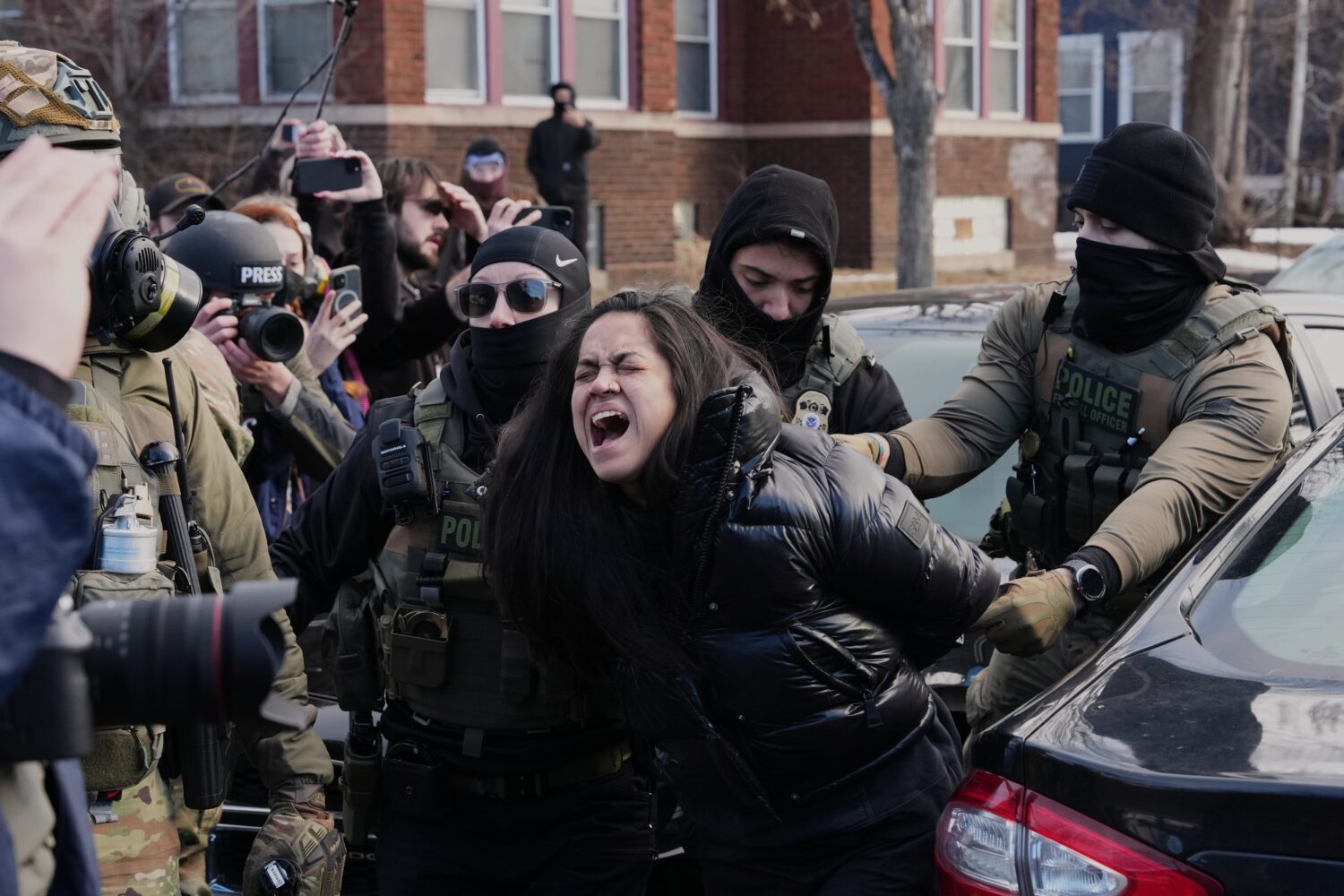CORRECTS FROM A PROTESTER TO A PERSON - A person is detained by federal agents near the scene where...