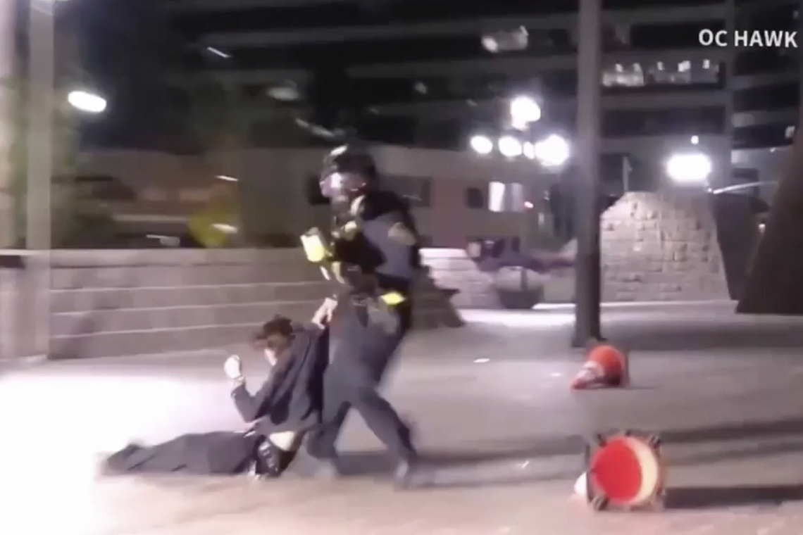 In this image taken from a video provided by OC Hawk, a federal officer drags a demonstrator hit in...